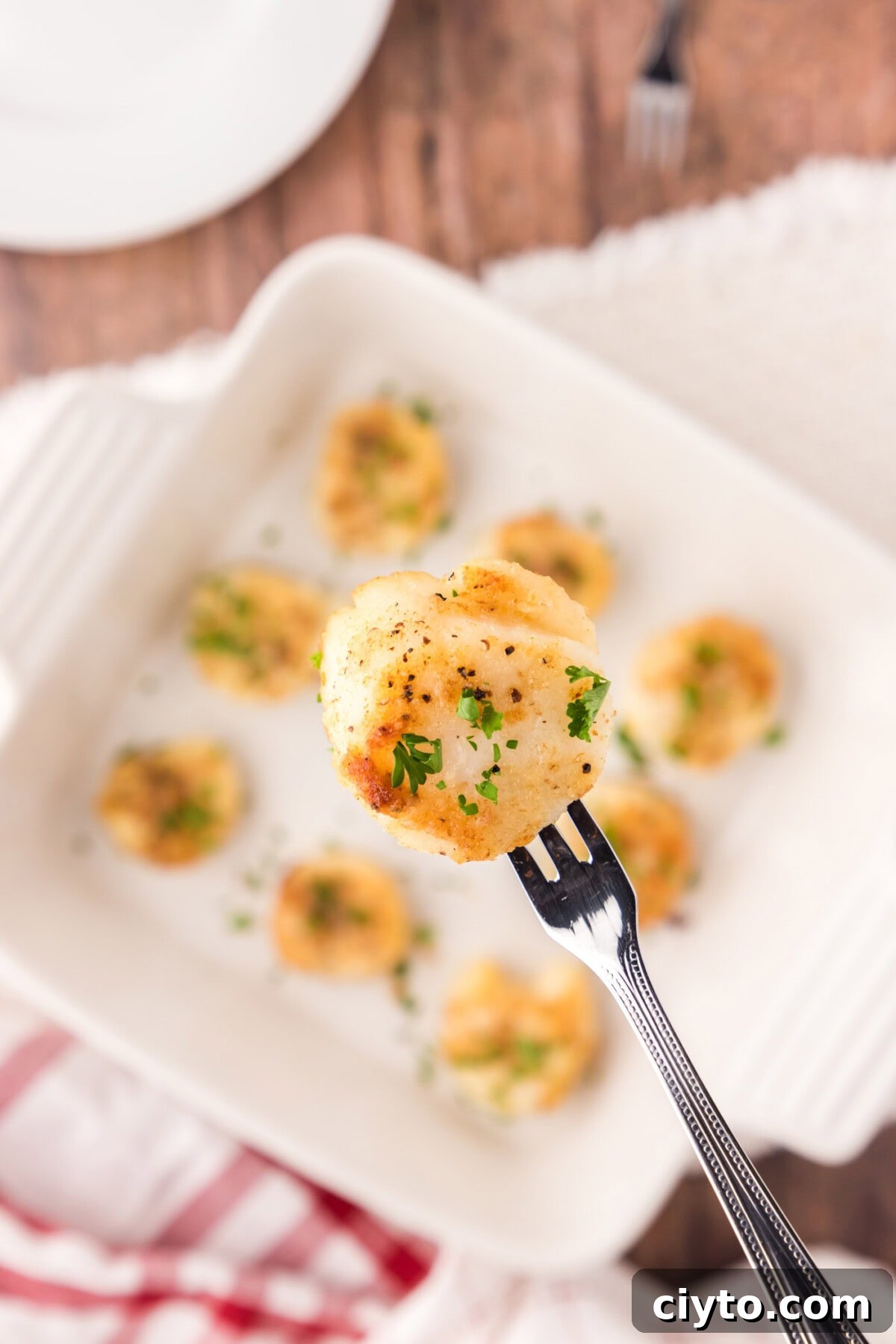 Garlic Butter Baked Scallops Recipe 2 Close up of a Baked Scallop on a seafood fork
