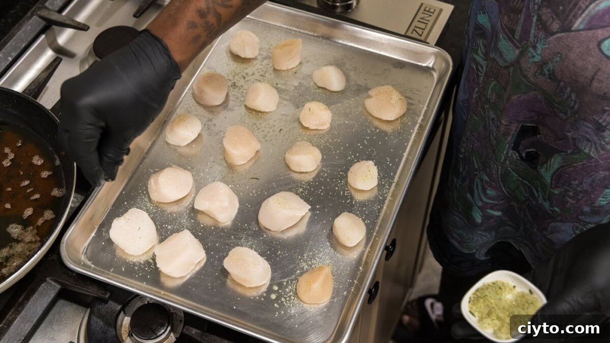 Garlic Butter Baked Scallops Recipe 5 scallops on a baking sheet
