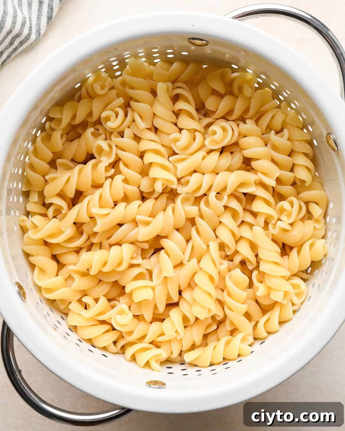 BLT Pasta Salad Recipe with Bacon, Tomato and Lettuce 7 cooked rotini noodles in a colander