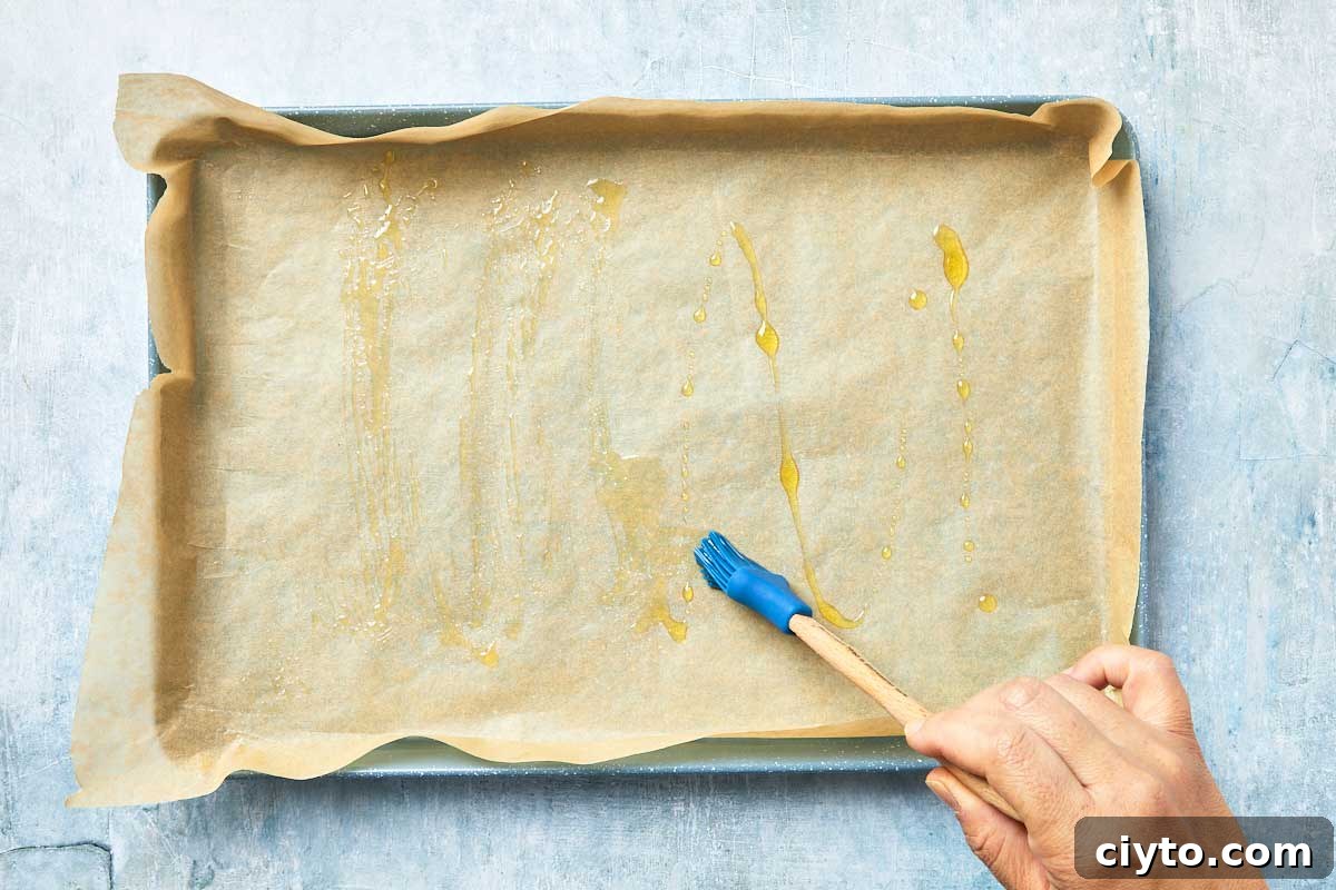 Rectangular baking pan lined with parchment and brushed with olive oil.