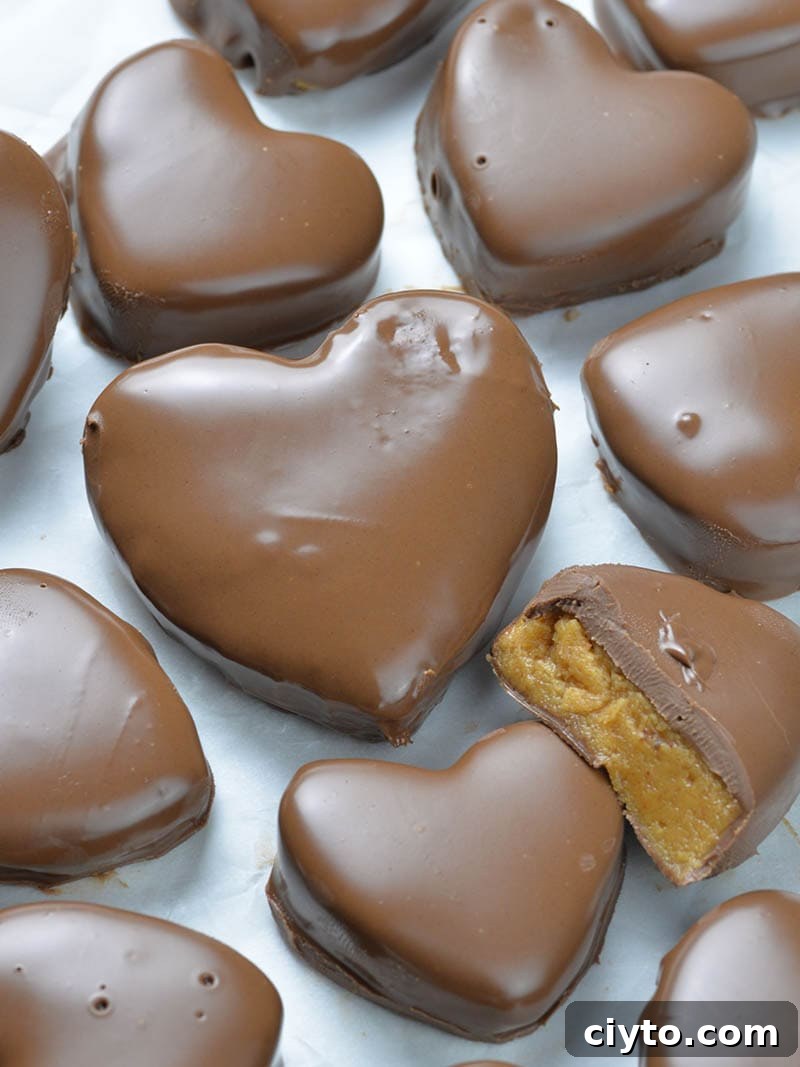 Bunch of Chocolate Peanut Butter Valentine’s Hearts on white paper.