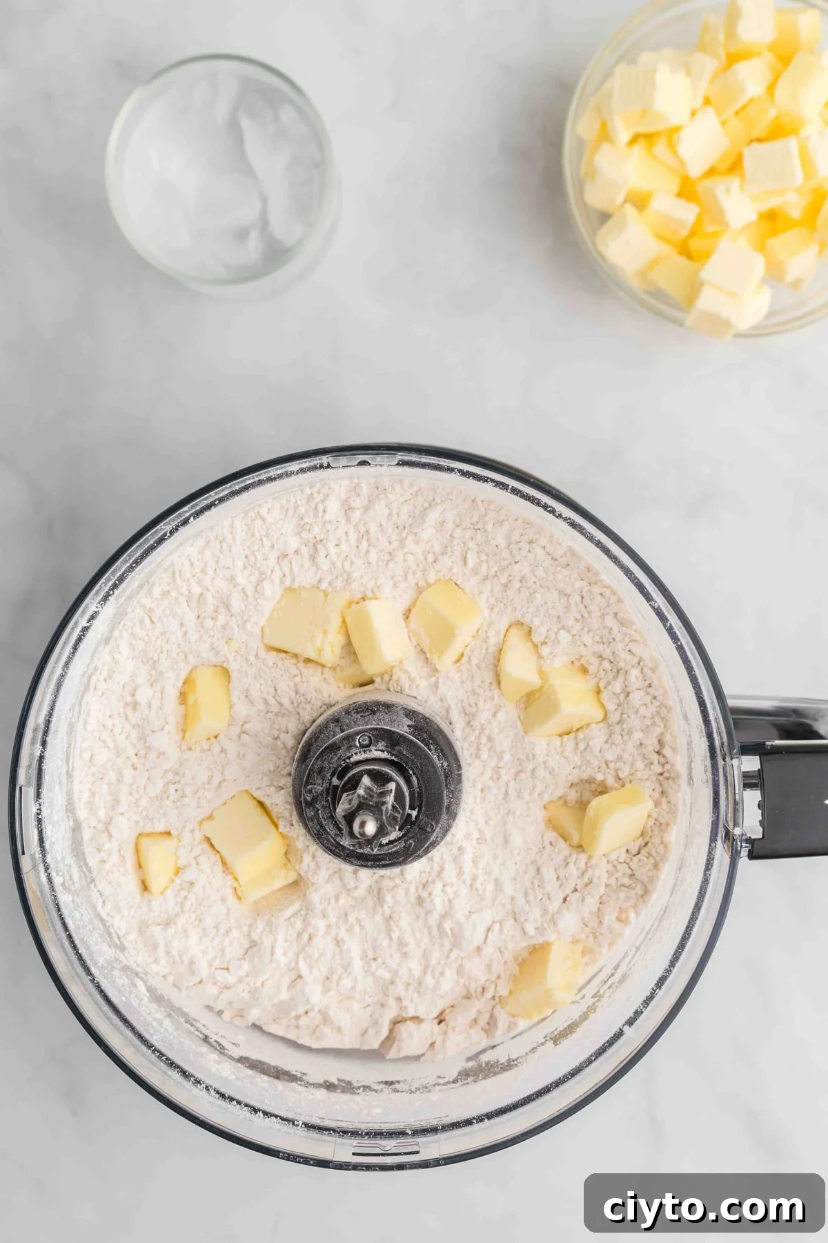 Cubes of butter with flour in a food processor