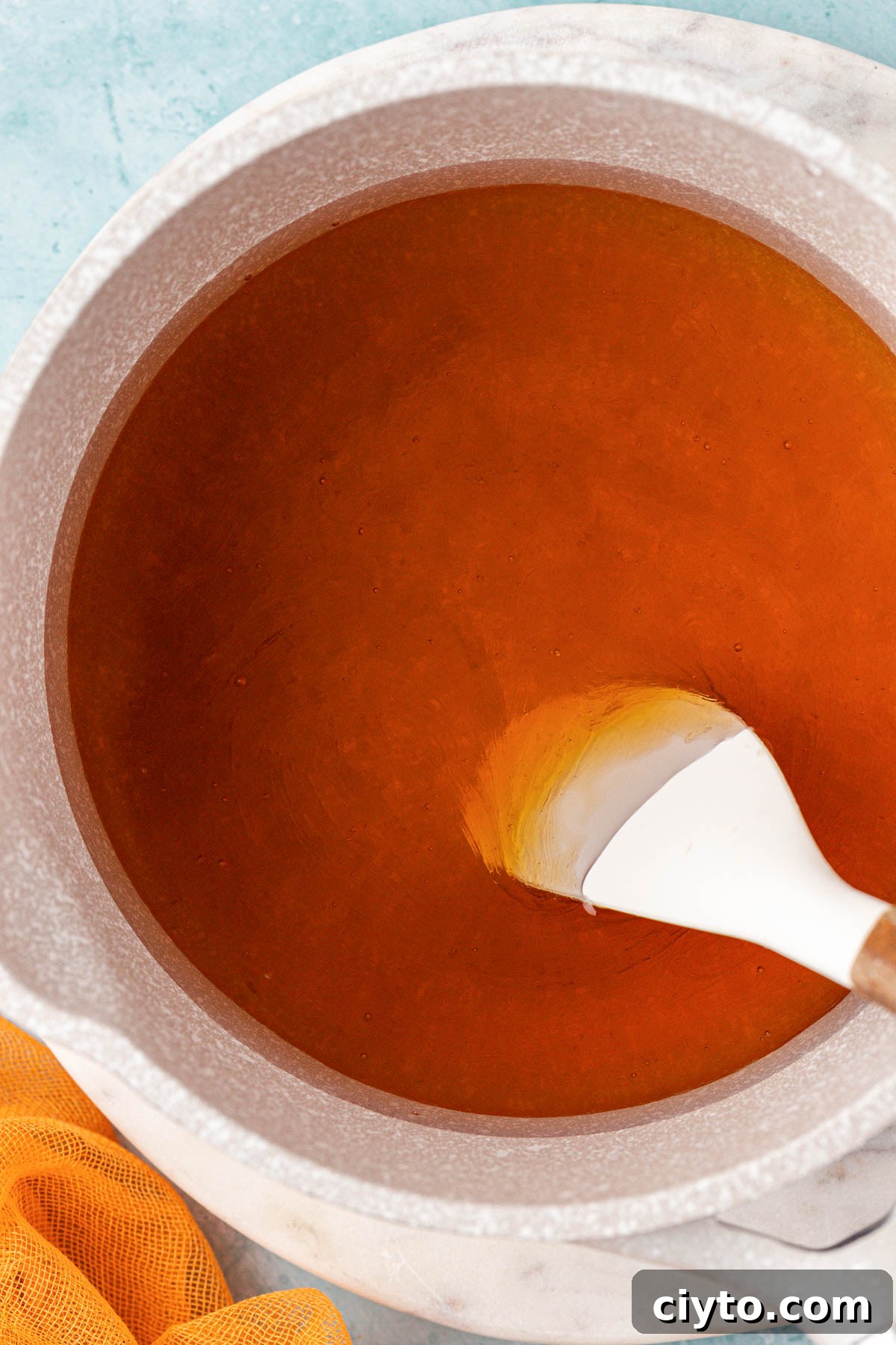 Honey simple syrup being prepared in a pot.