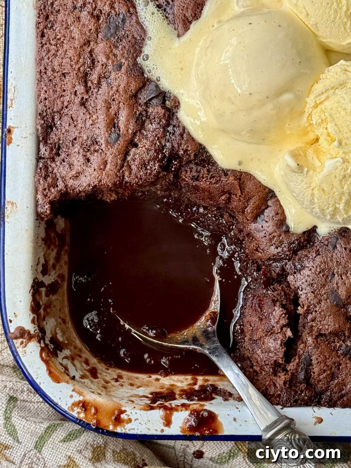 Chocolate Self-Saucing Pudding Recipe 2 self saucing chocolate pudding in enamel dish with ice cream on top.