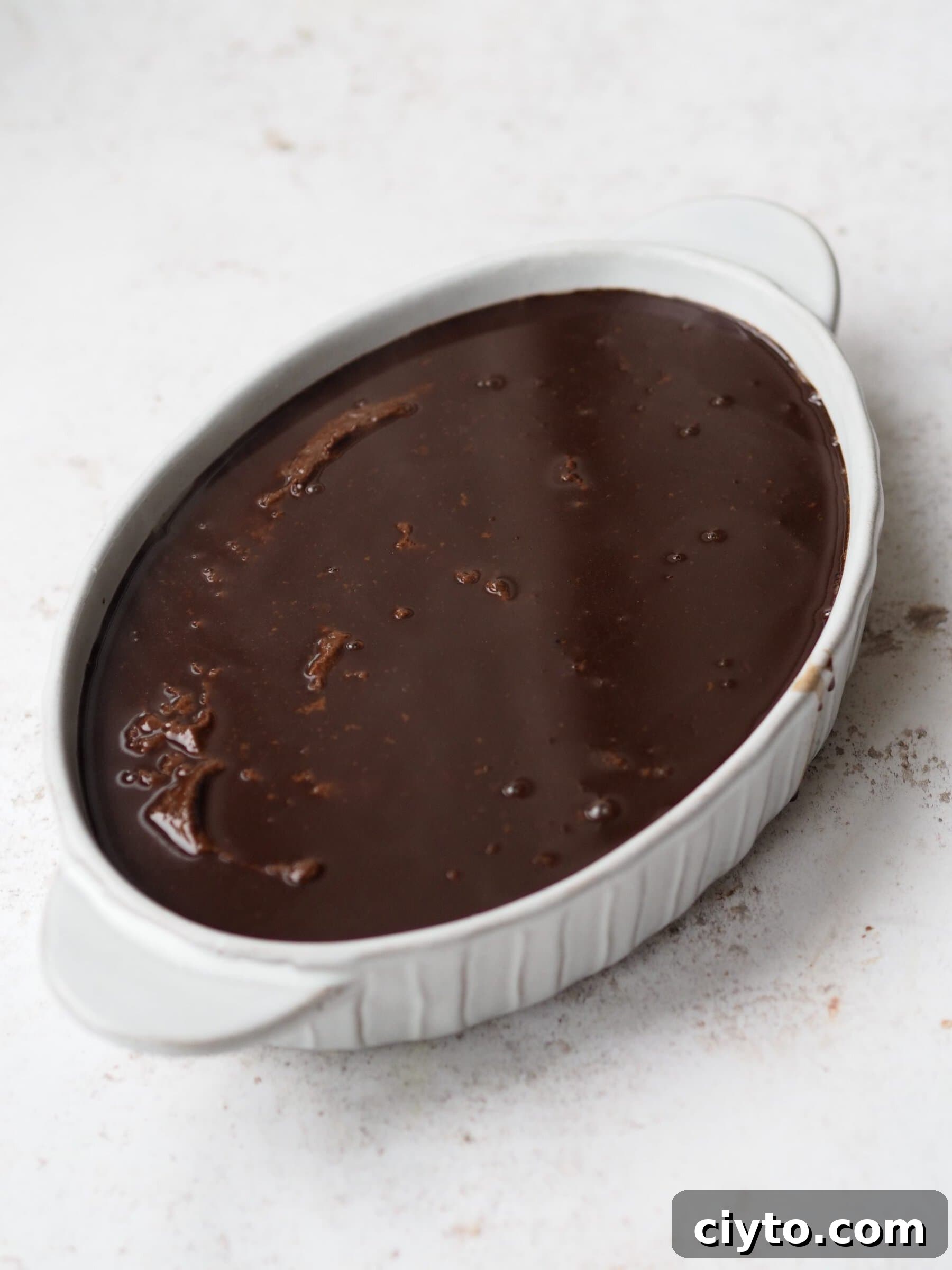 Chocolate Self-Saucing Pudding Recipe 9 Self Saucing Chocolate Pudding in a white baking dish before baking.