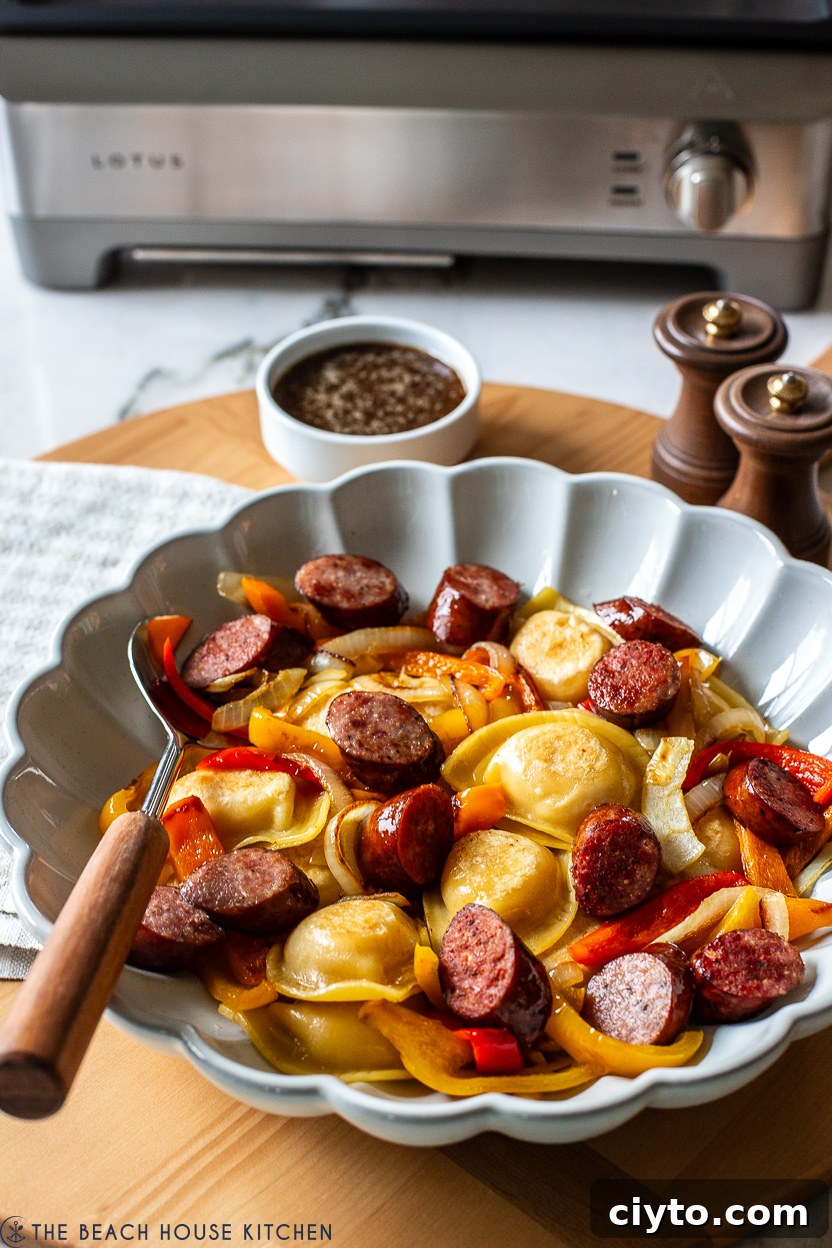 Serving dish filled with Pierogies, Kielbasa, Peppers and Onions