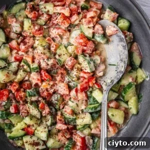 Bowl of tahini chopped salad with sumac garnish.